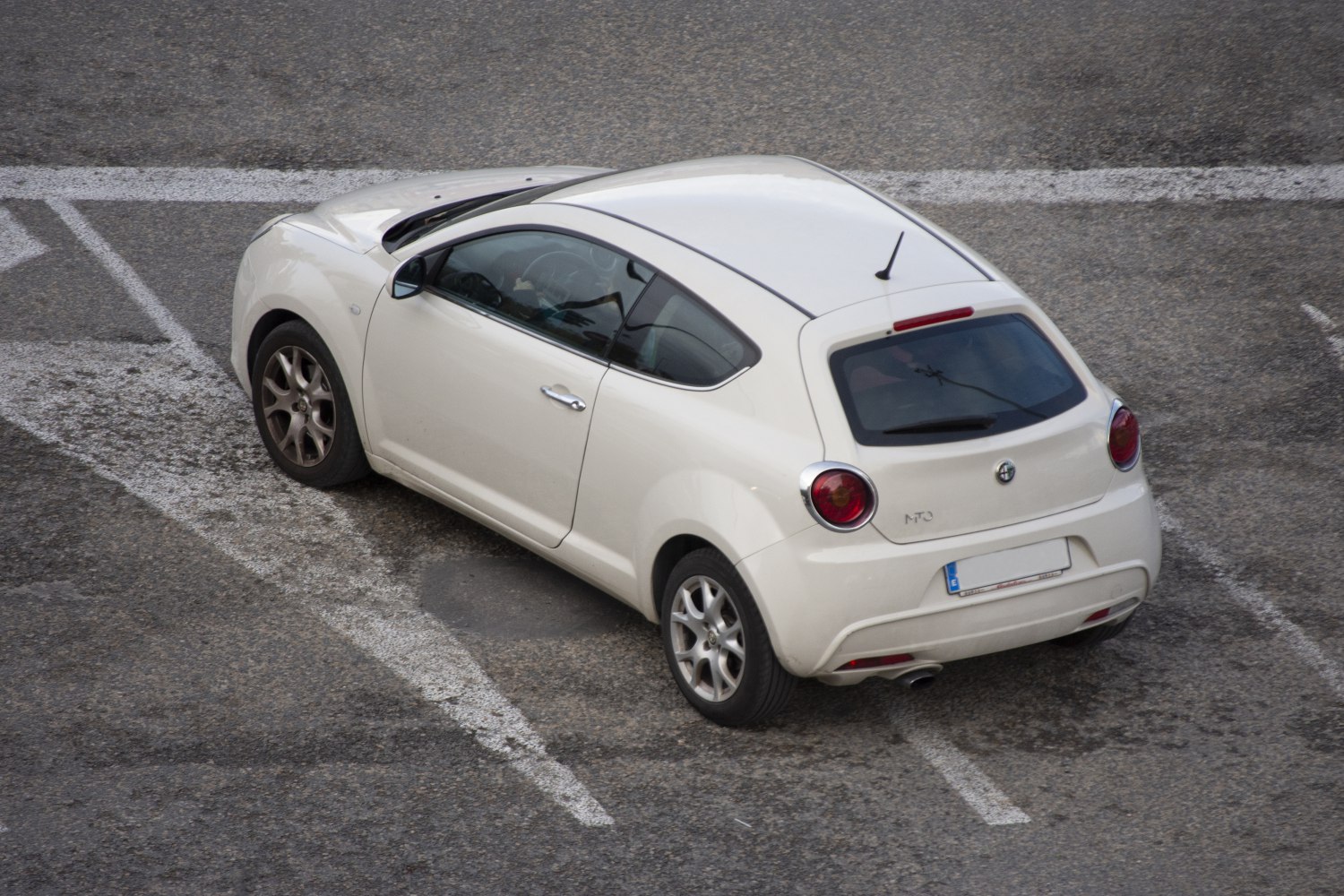 Rear and side view of compact 3-door hatchback with rounded rear lights.