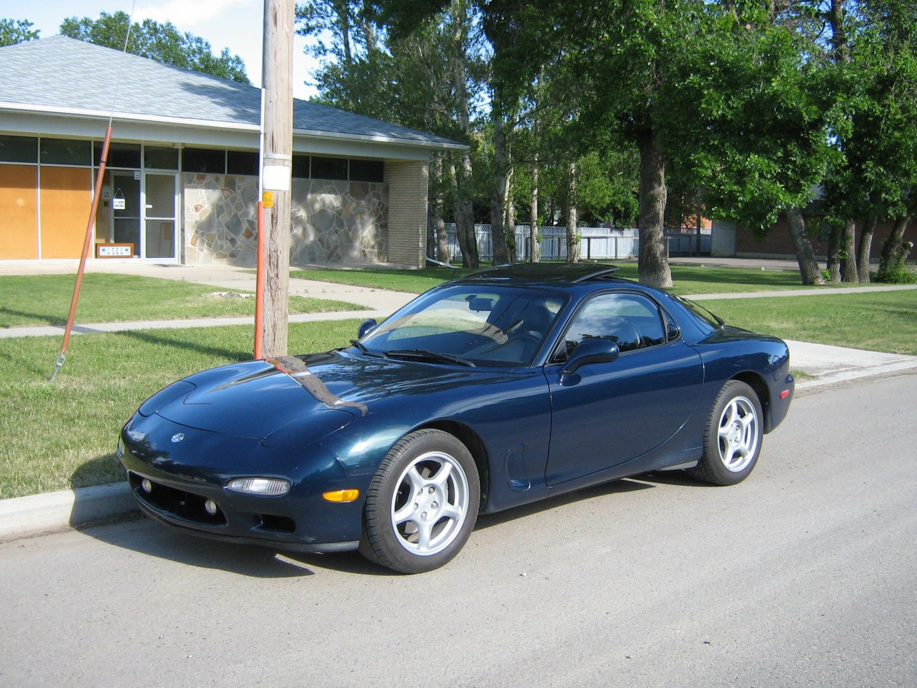 Aerodynamic sports coupe with pop-up headlights and alloy wheels