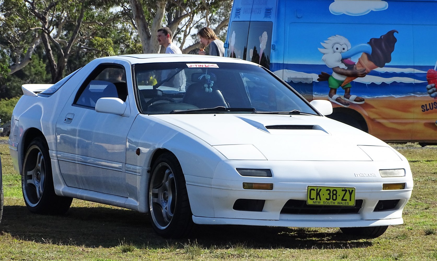 White sports coupe with hood scoop and rear spoiler
