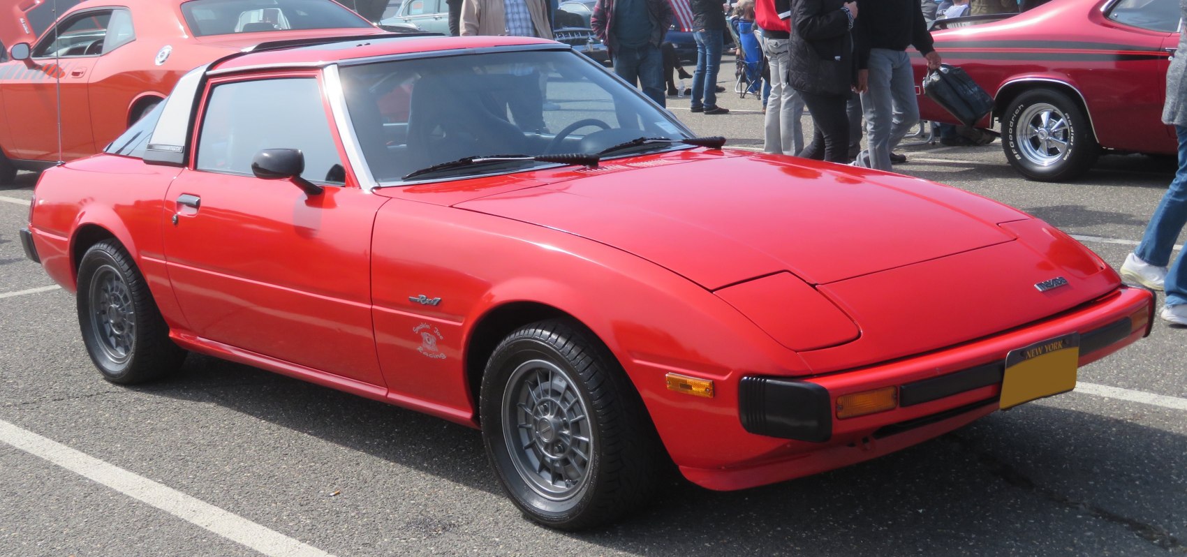 Classic targa roof with pop-up headlights on a vintage sporty coupe.