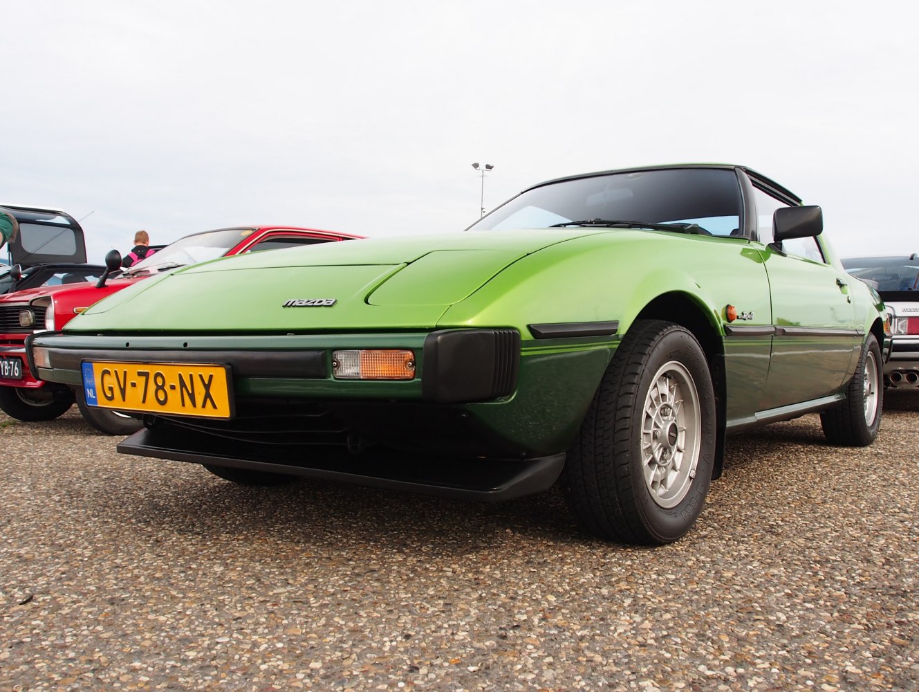 Low-angle view of vintage green sports coupe front and side