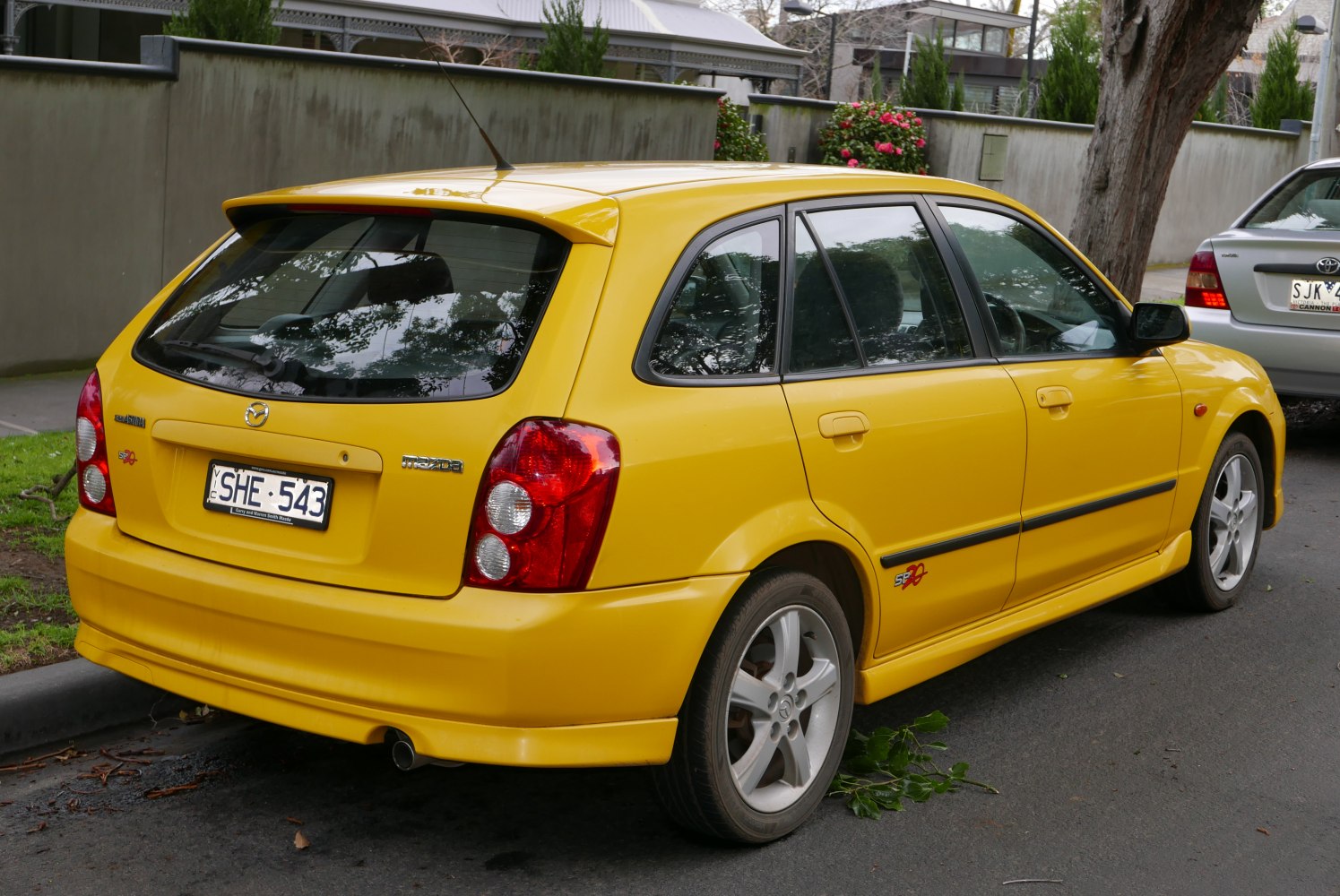 Yellow 5-door hatchback rear with alloy wheels and distinctive taillights