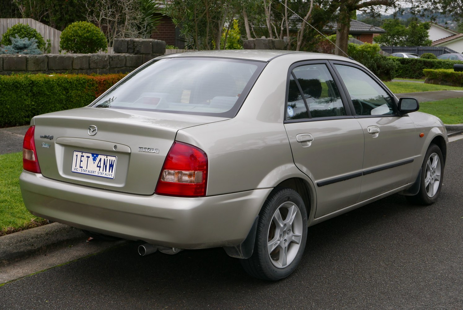 Rear view of a sedan with alloy wheels and rear roof antenna