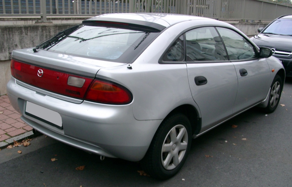 Compact hatchback rear view with integrated rear light panel and aerodynamic shape.