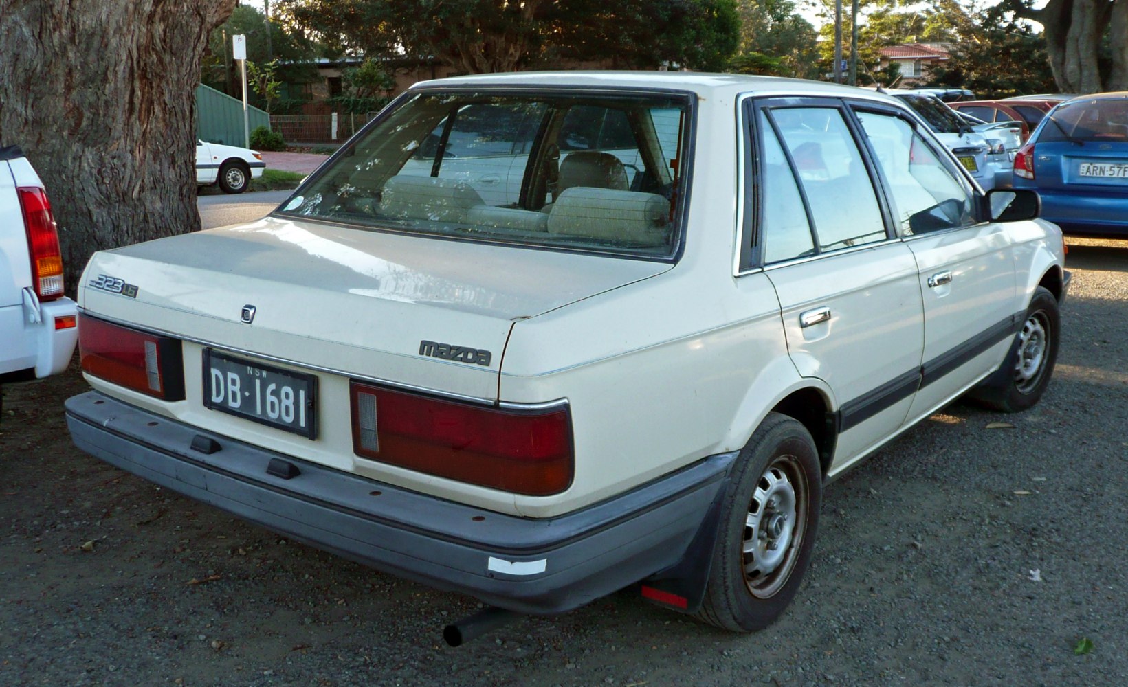 Rear side view of a classic 1980s sedan with distinctive tail lights and trim