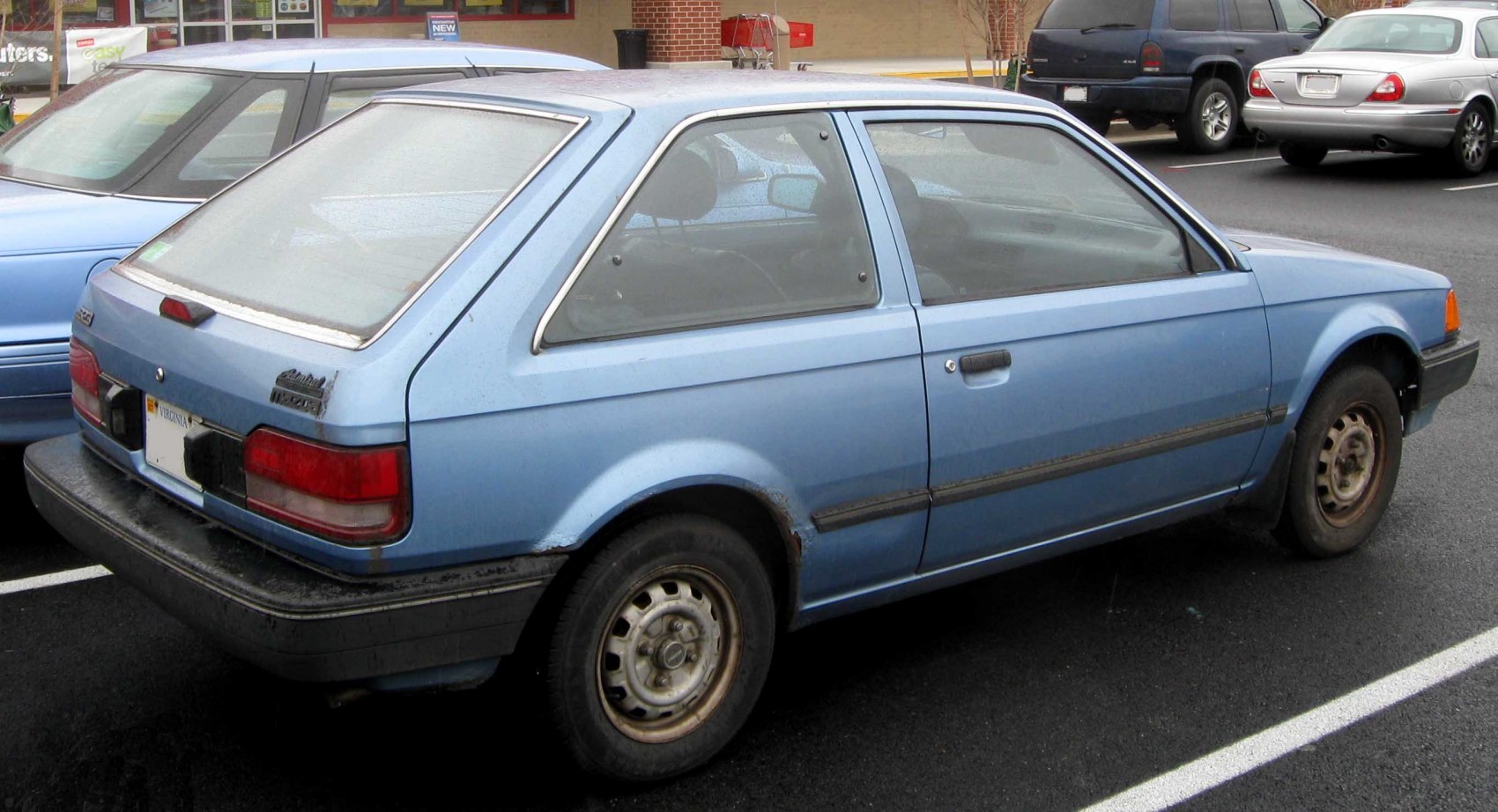 Vintage compact hatchback with steel wheels and black bumpers