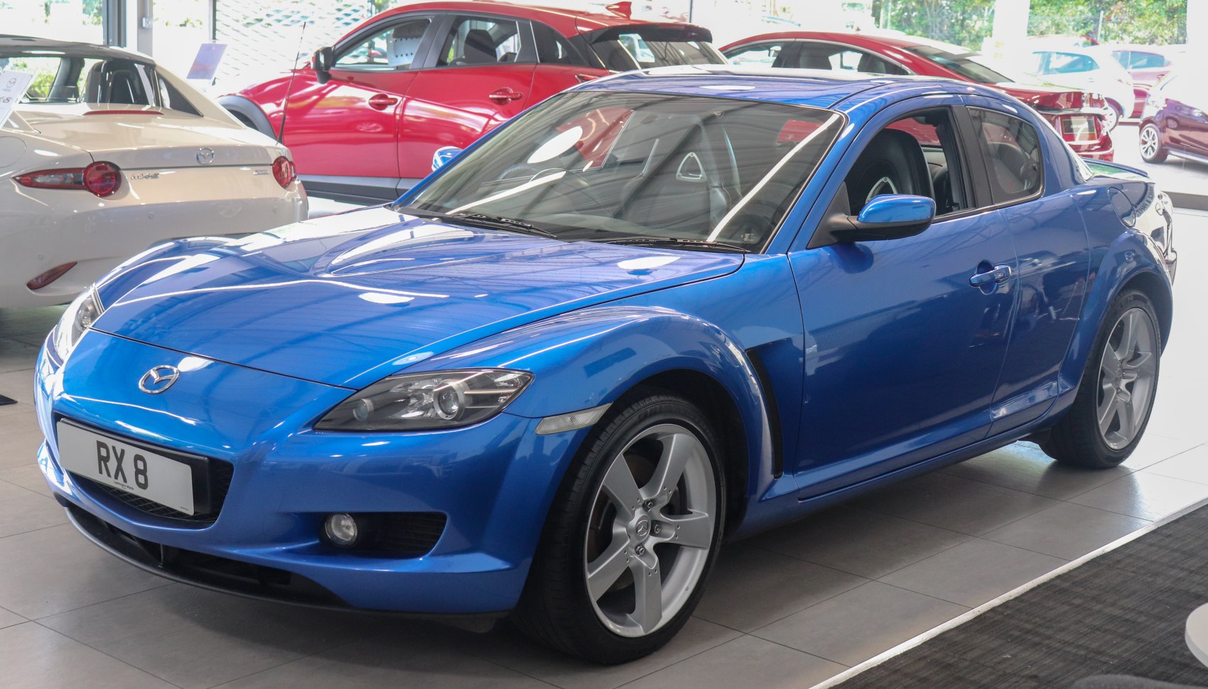 Blue 4-door sports coupe with sleek front-side design