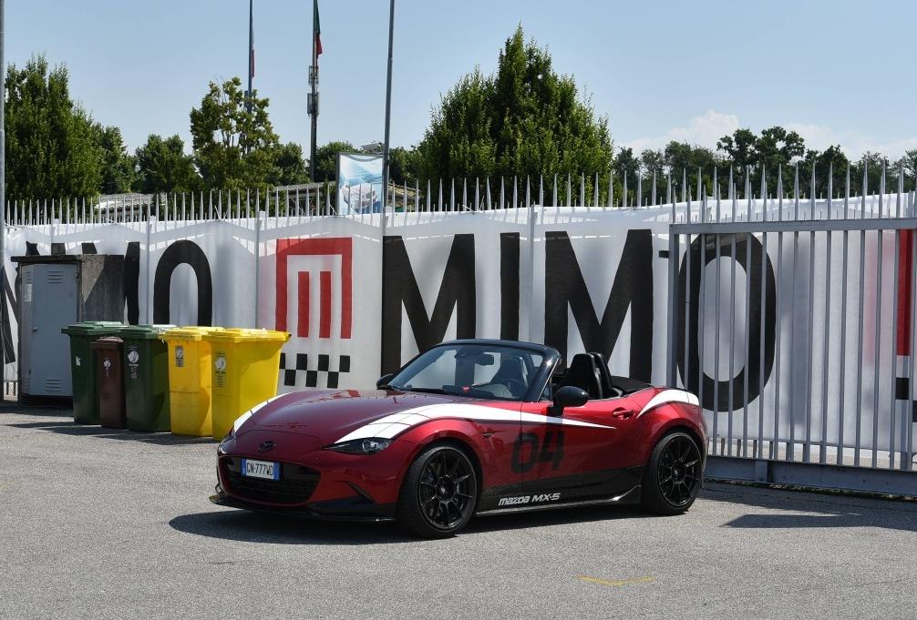 Red convertible with white racing stripes and black wheels