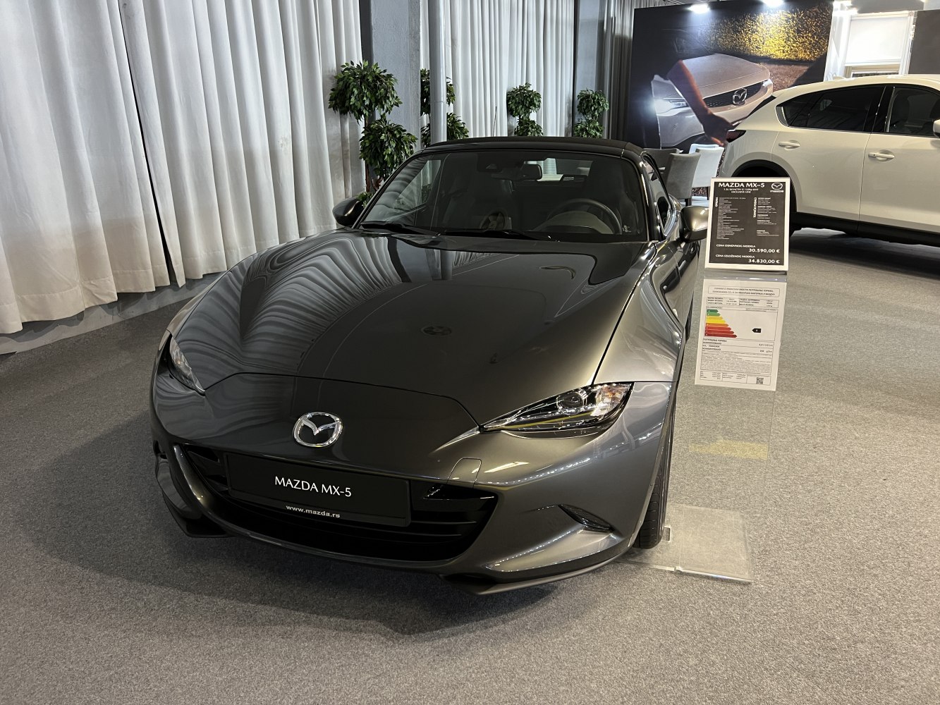 Front view of a sports roadster with sleek headlights and aerodynamic hood