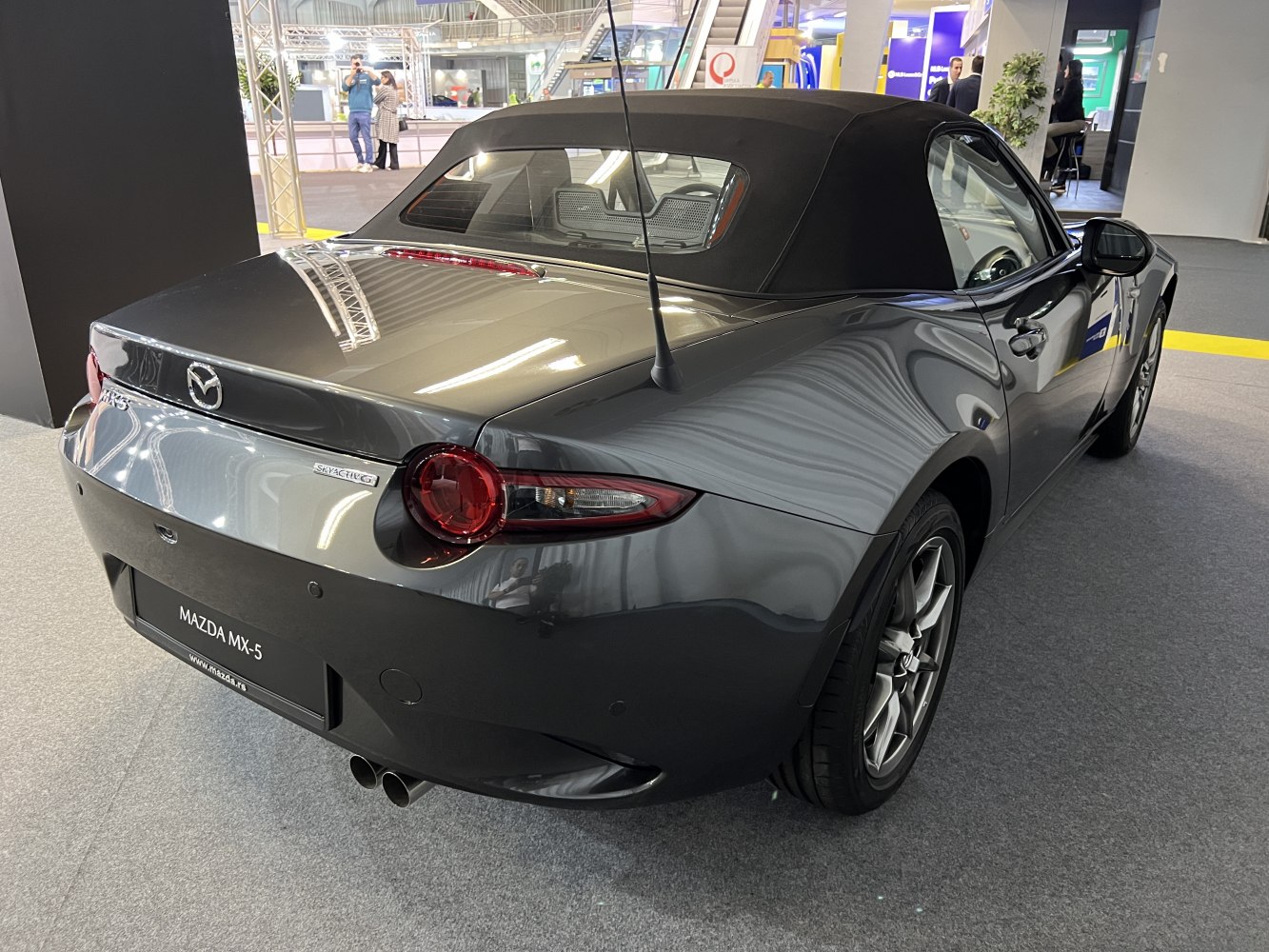 Rear view of convertible with soft top and dual exhaust