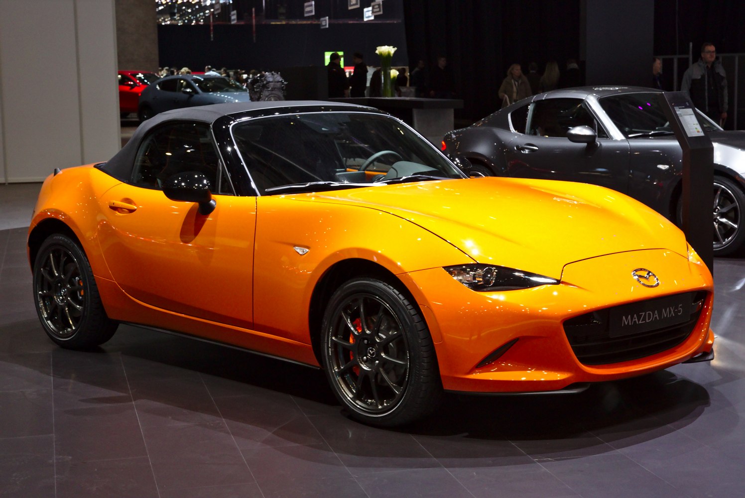 Bright orange convertible roadster with sporty design and aerodynamic features