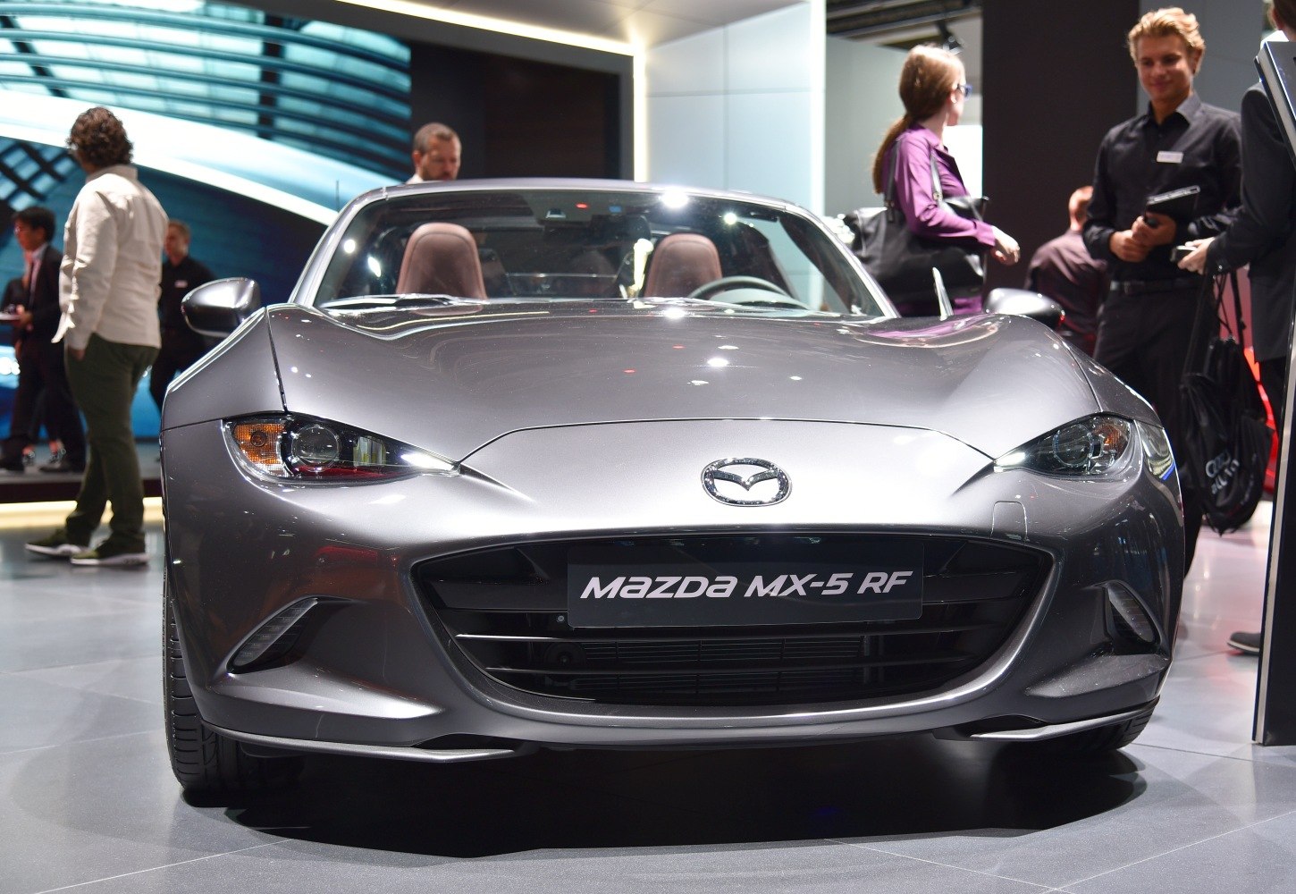 Sleek front view of a roadster with distinctive headlights and grille.