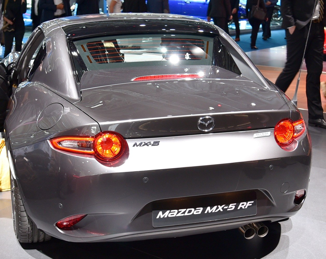 Rear view of sporty coupe with round taillights and dual exhaust