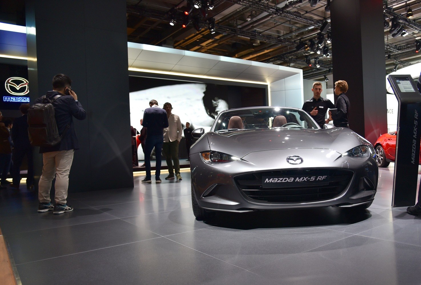 Sporty convertible roadster front with sleek headlights and aggressive grille