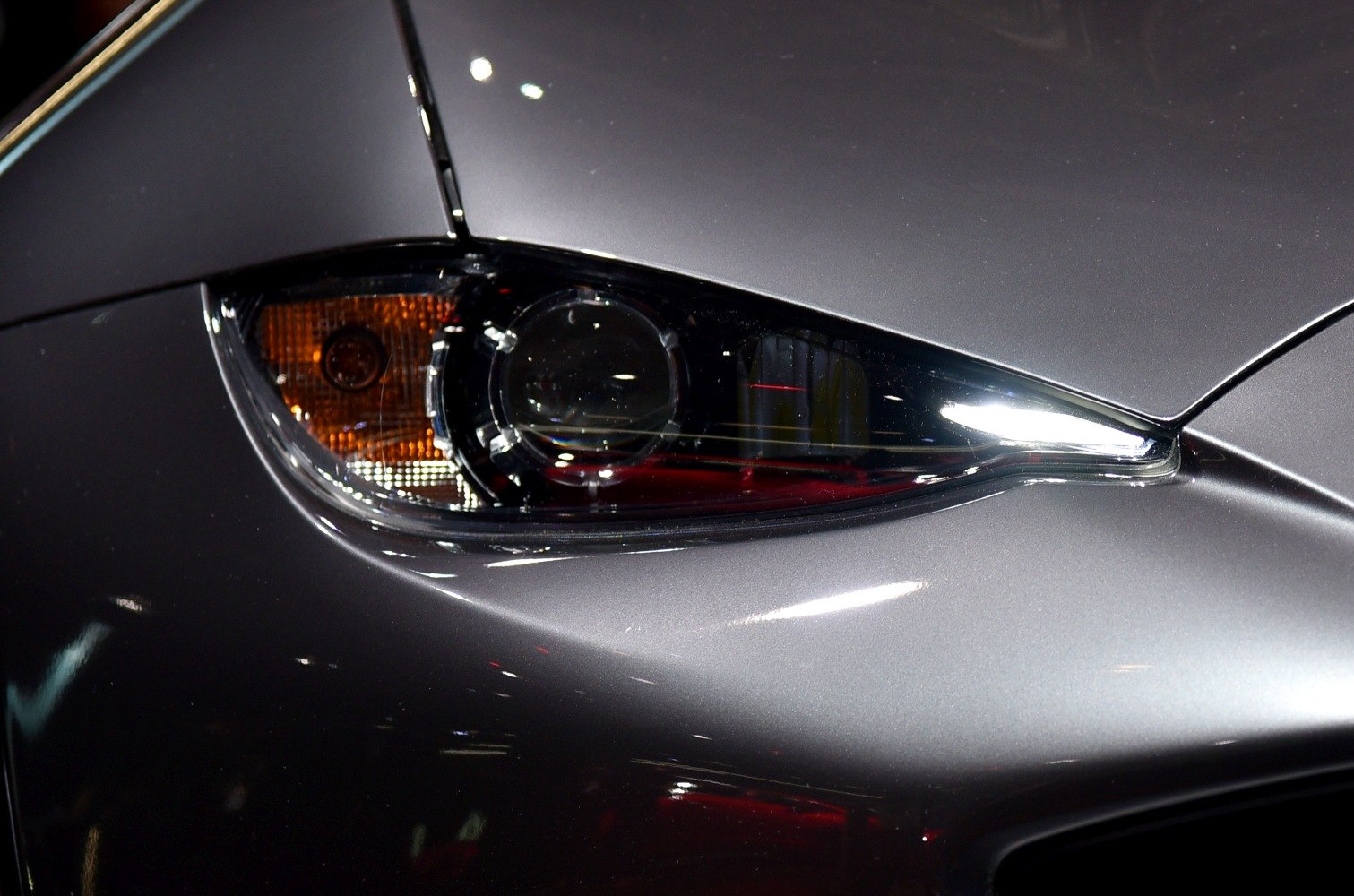 Close-up of sleek headlight with integrated projector and LED strip