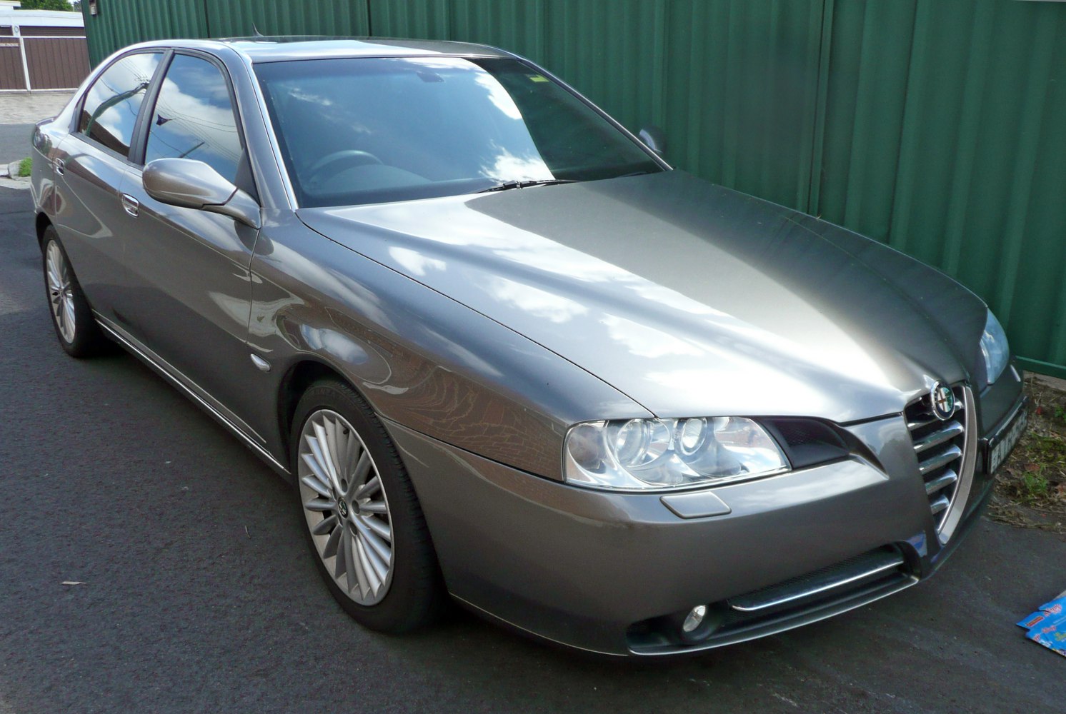 Front side view showing headlights, grille, and alloy wheels
