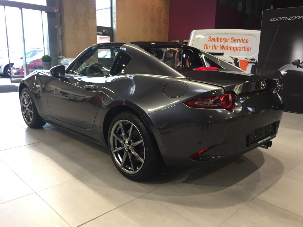 Sporty roadster with retractable hardtop and sleek rear design