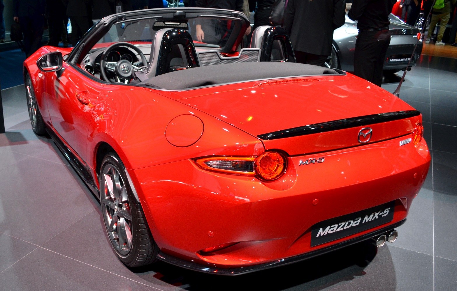 Rear view of red convertible with dual exhaust and sporty taillights
