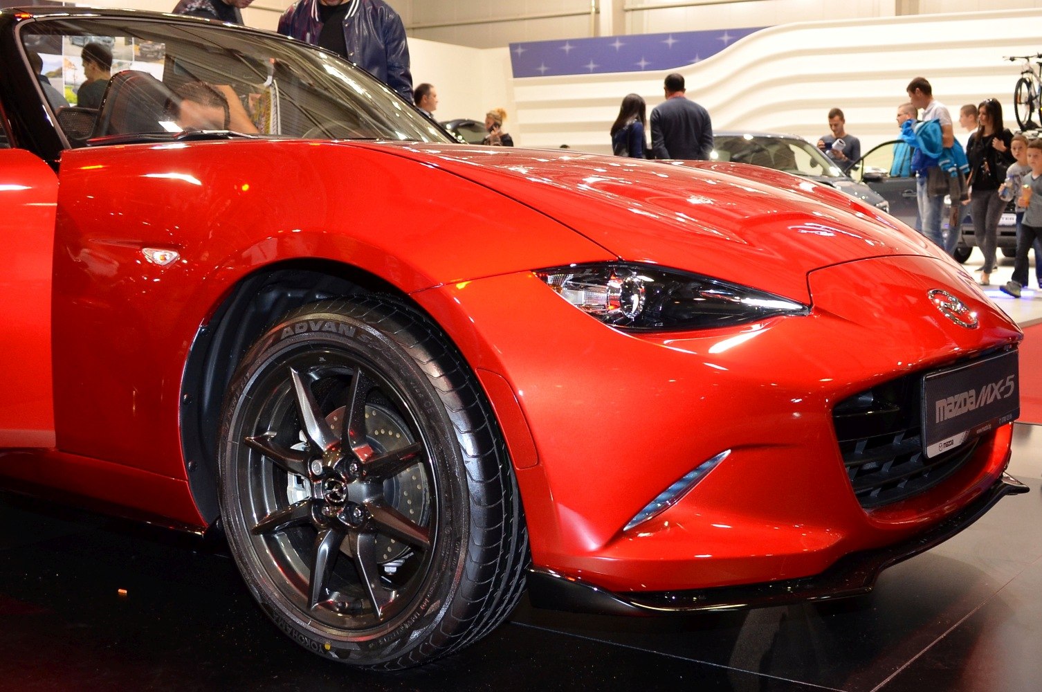 Front view with black alloy wheel and sleek headlight design