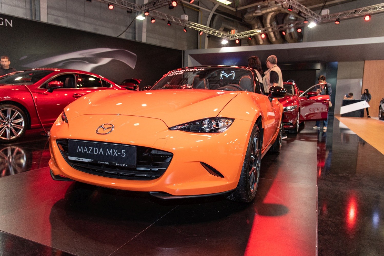 Bright orange convertible sports car front view with sleek headlights