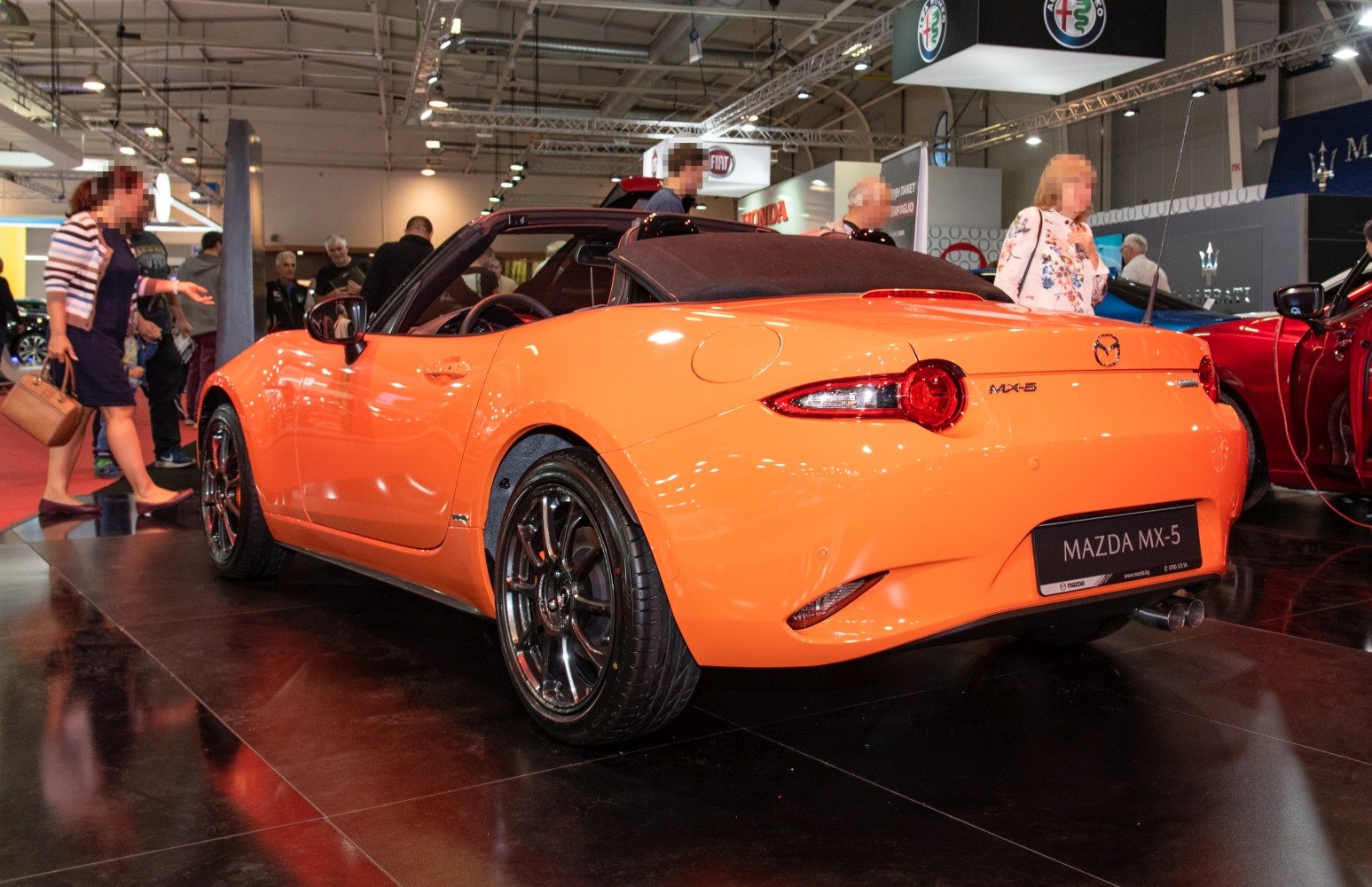 Convertible roadster rear view with tail lights and black soft top