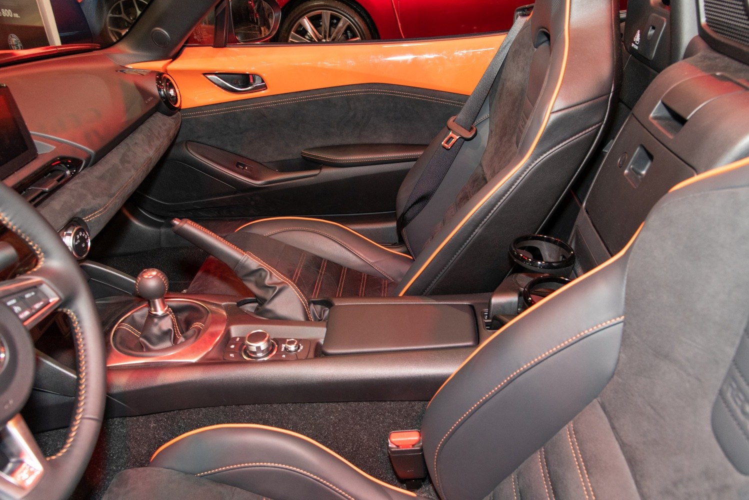 Black leather seats with orange stitching and manual gear shift