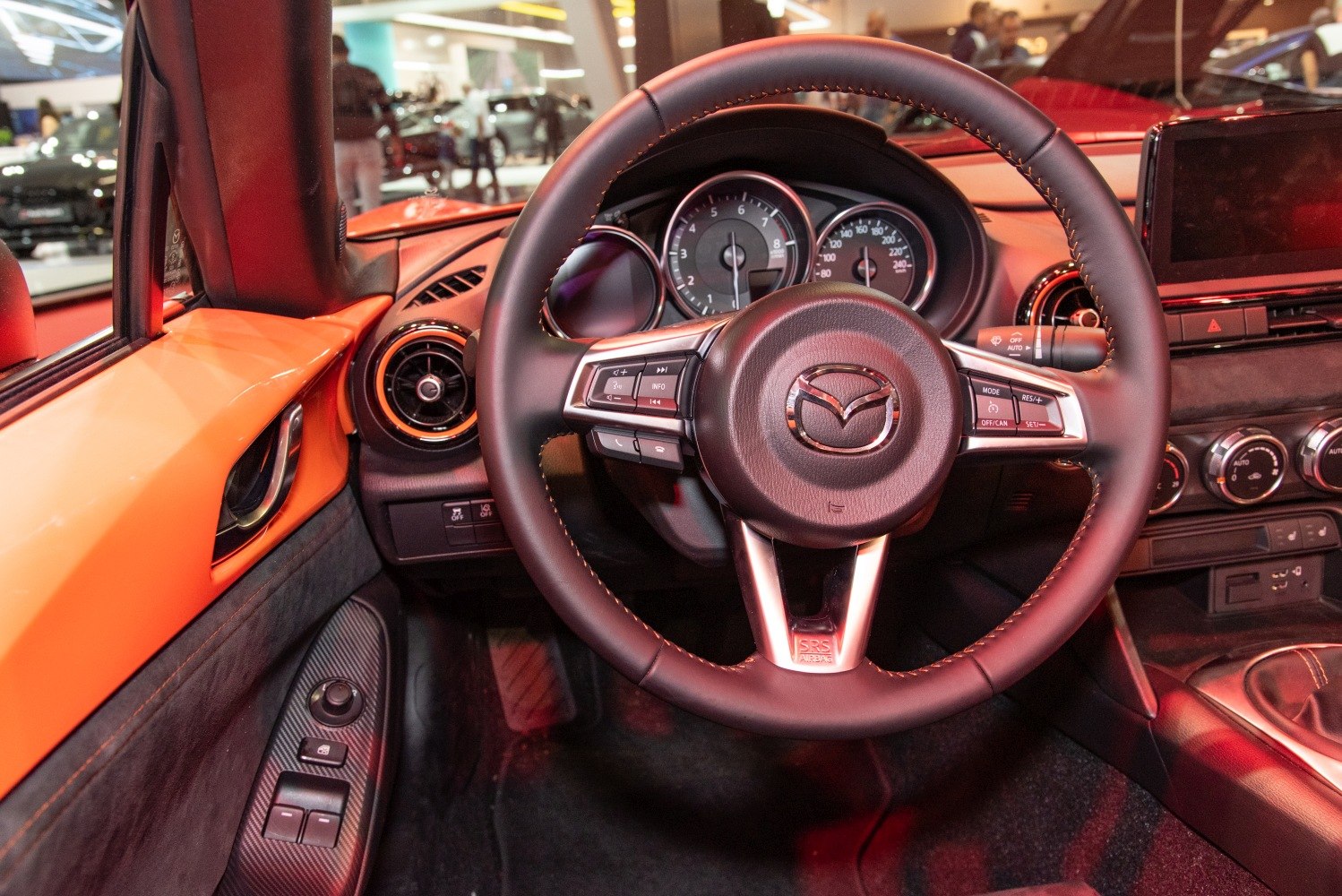 Steering wheel and dashboard close-up with controls and speedometer