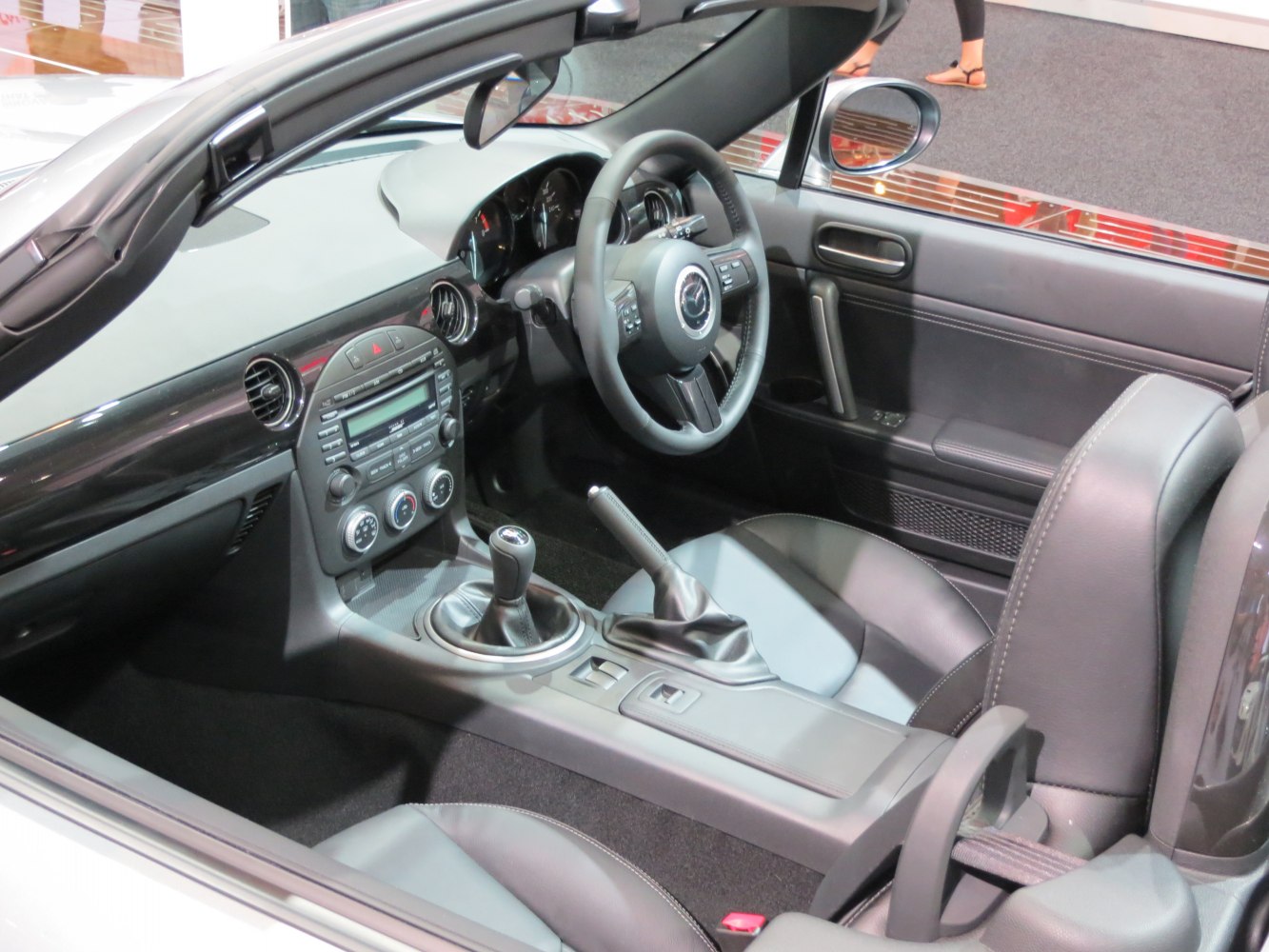 Modern hardtop sports car interior with manual transmission and dashboard details
