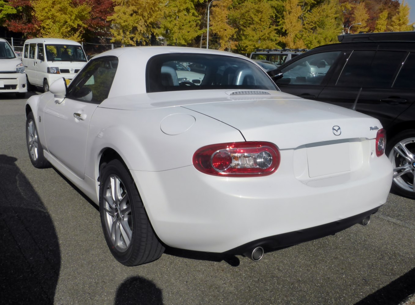 Rear view of white hardtop coupe with oval tail lights and dual exhausts