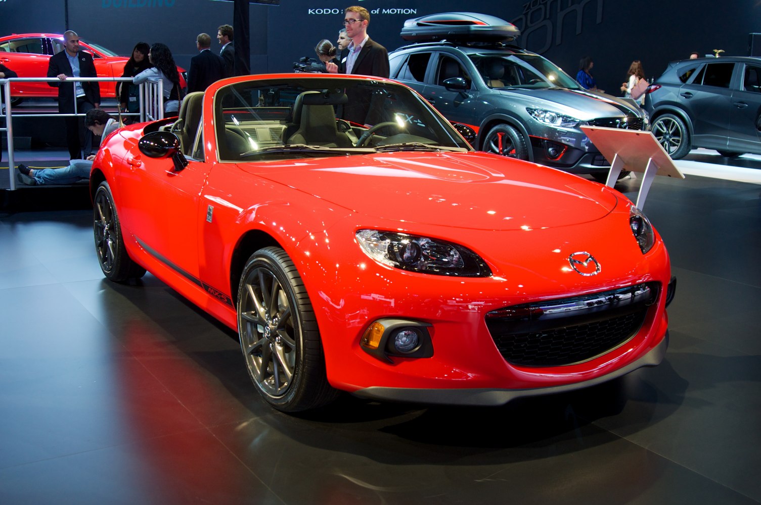 Red convertible roadster with sporty front grille and headlights