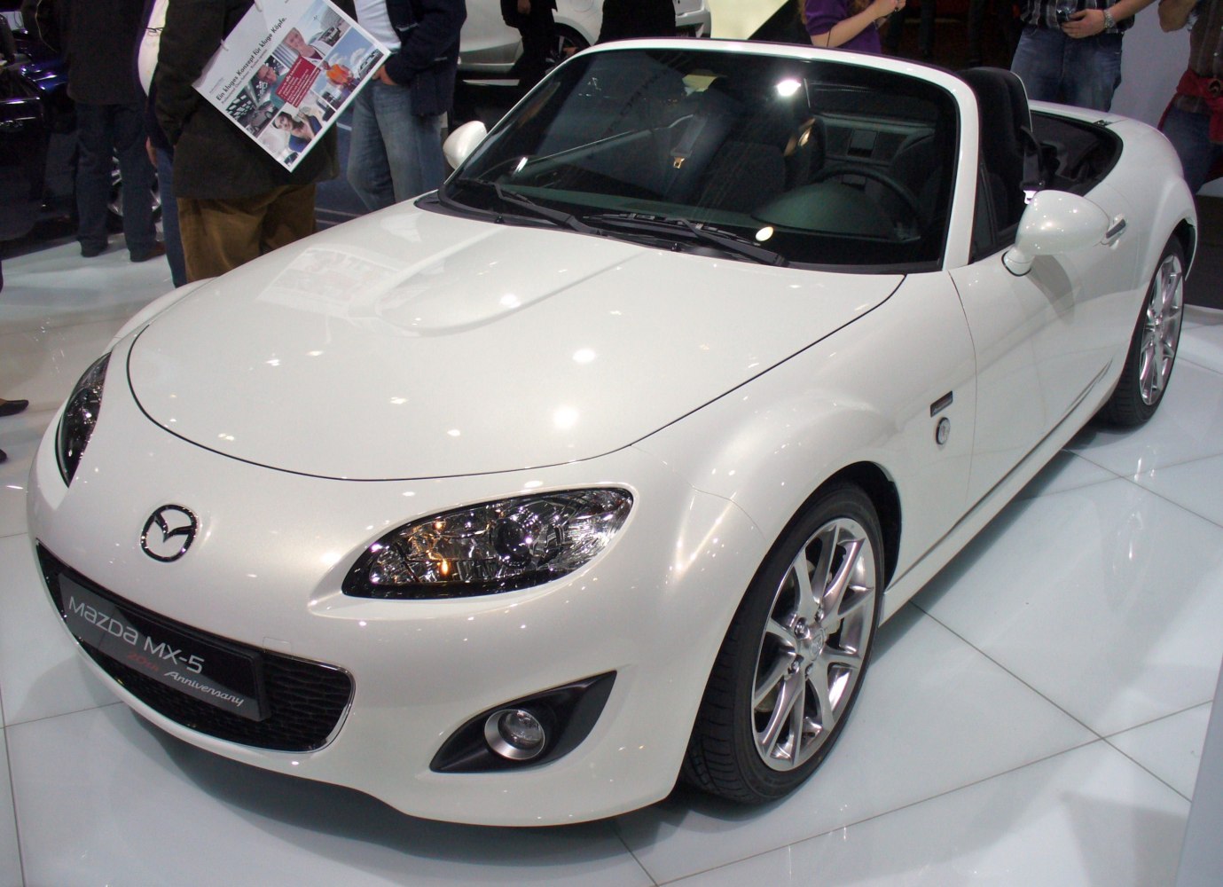 White convertible sports car with sleek body and alloy wheels