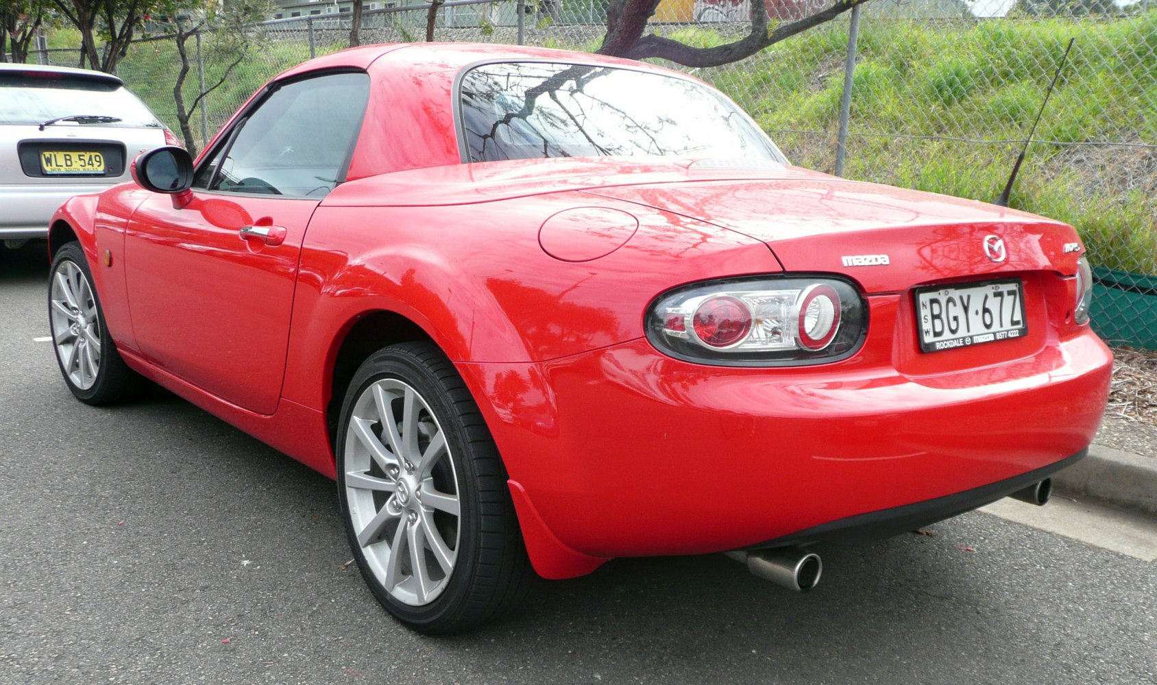 Red rear-side view with sporty taillights and alloy wheels