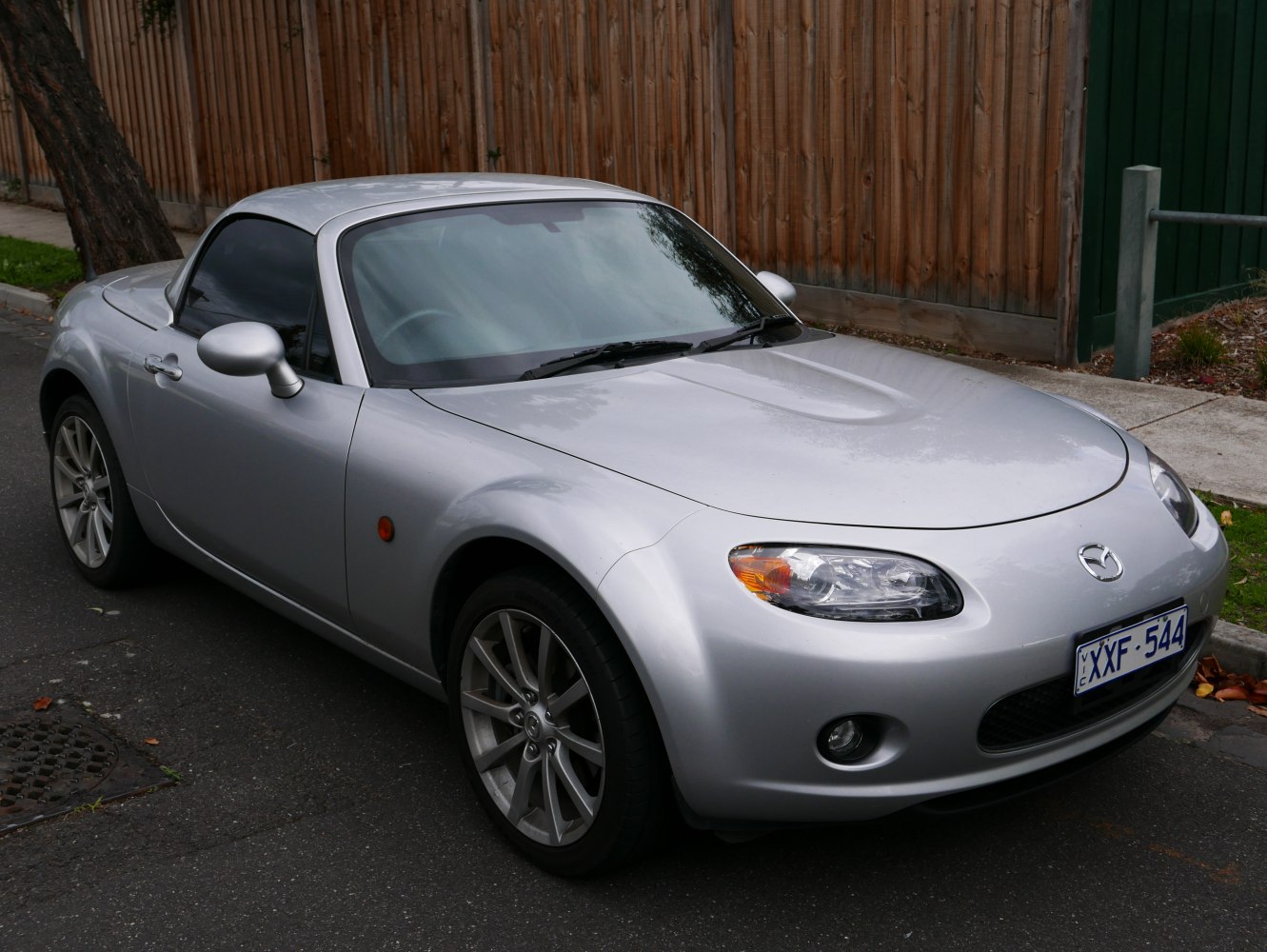 Silver roadster with hardtop and distinctive headlights