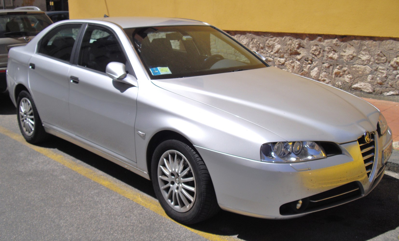 Silver sedan with distinctive front grille and headlights