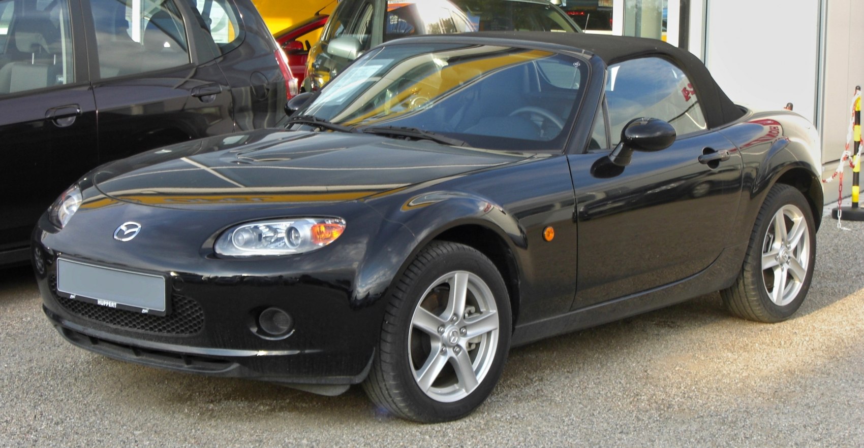 Black Mazda MX-5 III soft top convertible front and side view