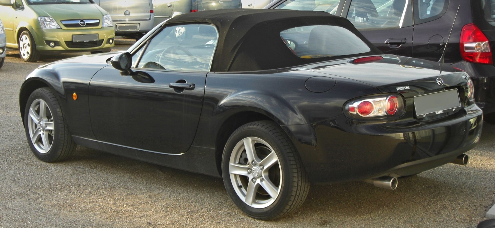 Convertible with black soft top and sporty alloy wheels