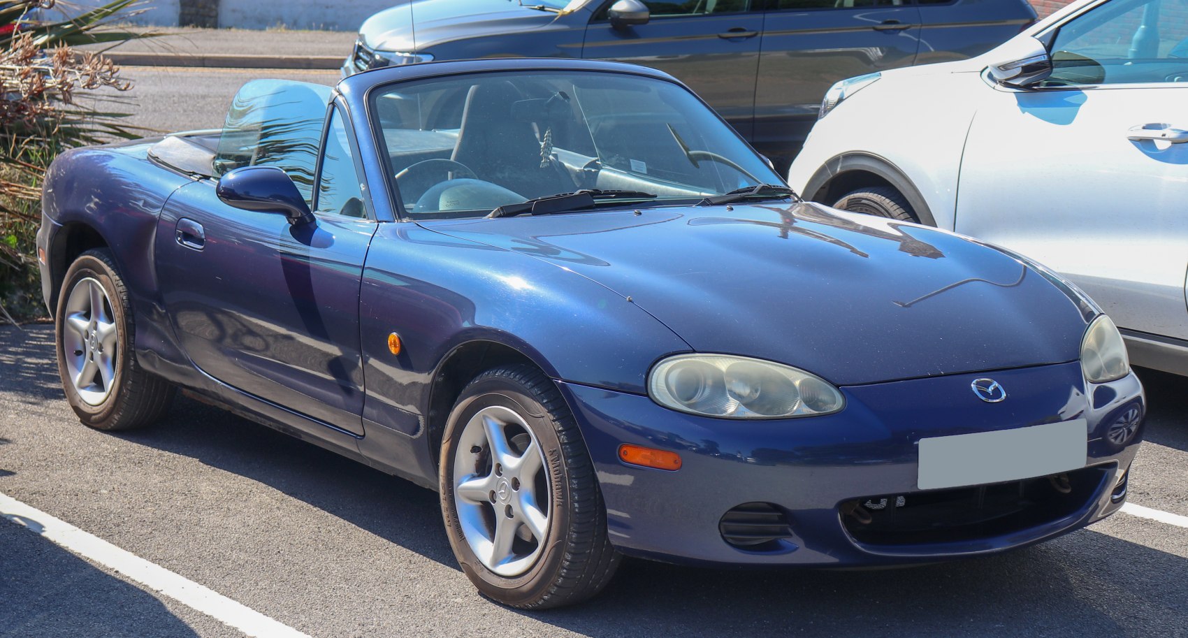 Convertible two-seater roadster with sporty compact design and smooth curves.