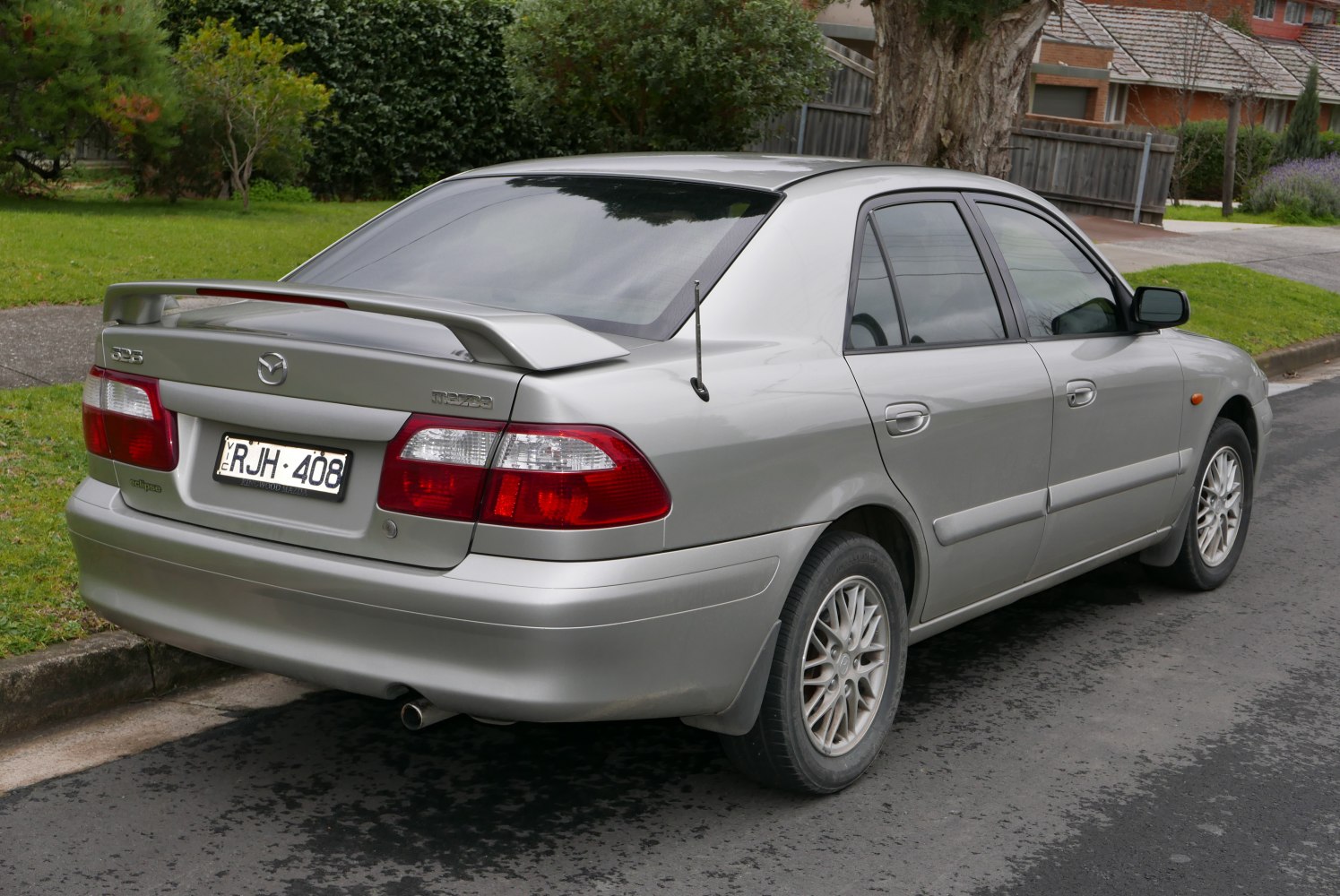 Silver sedan rear with spoiler and alloy wheels