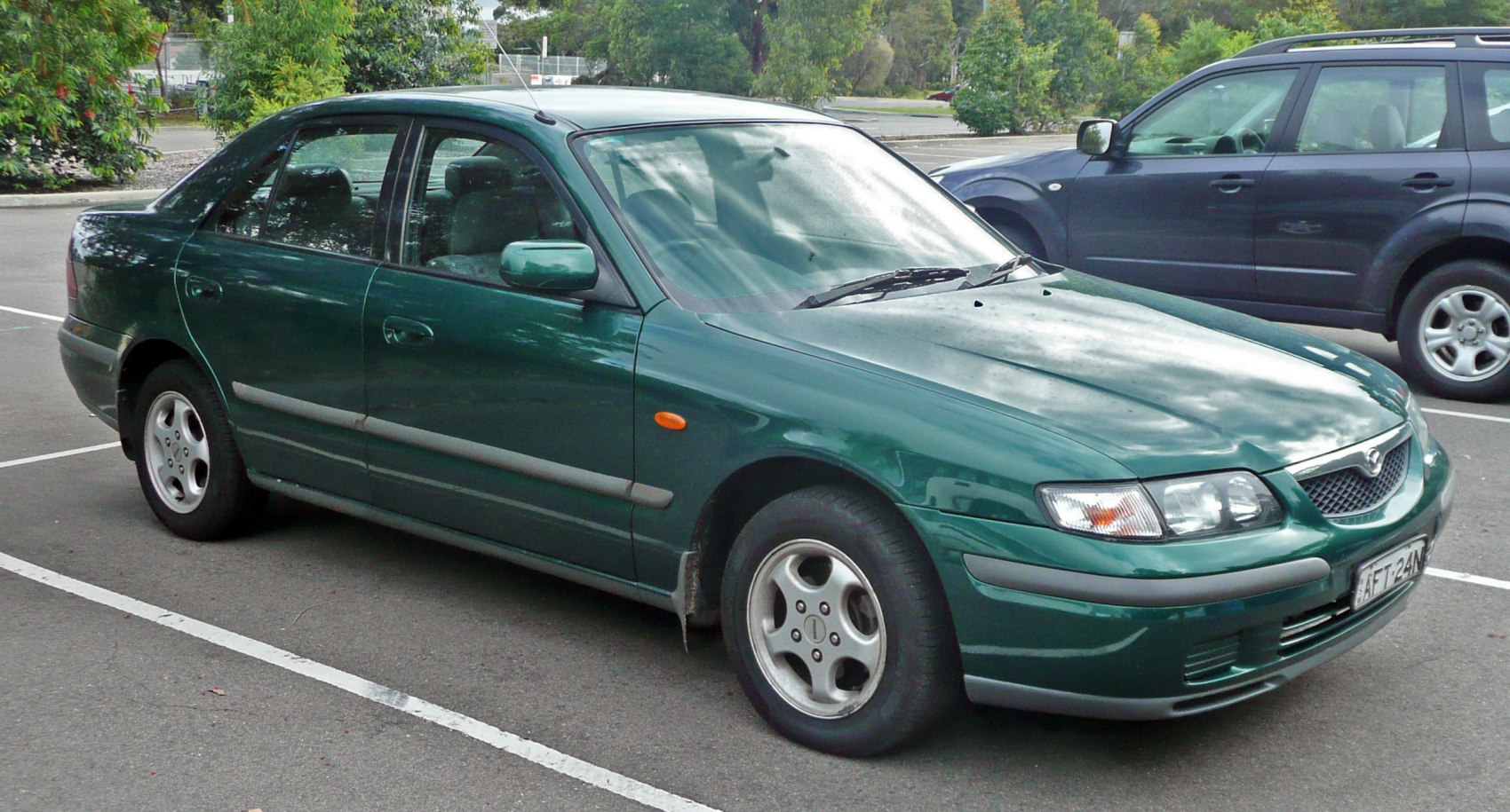 Four-door sedan with alloy wheels and front side view.