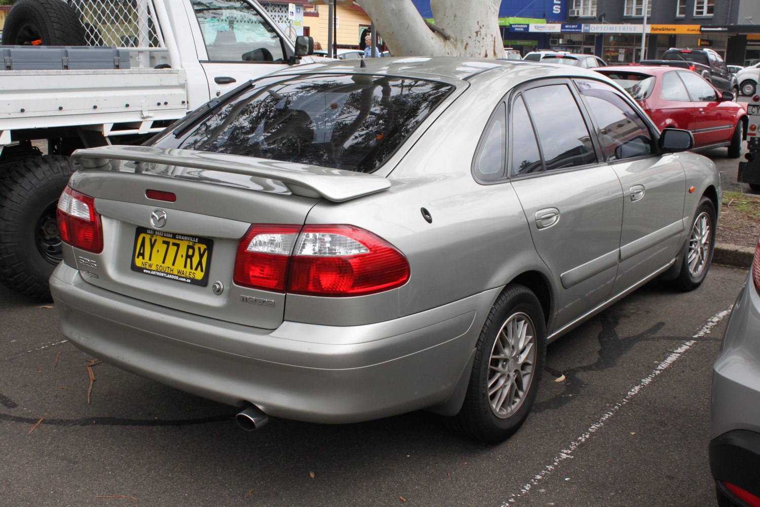 Rear view of hatchback with spoiler and alloy wheels