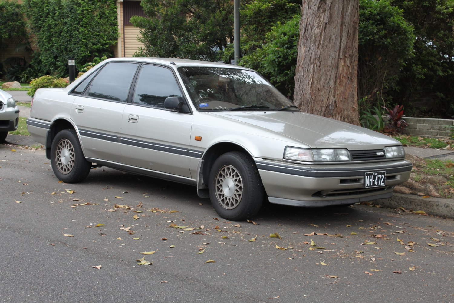Classic mid-size sedan with alloy wheels and pop-up headlights.