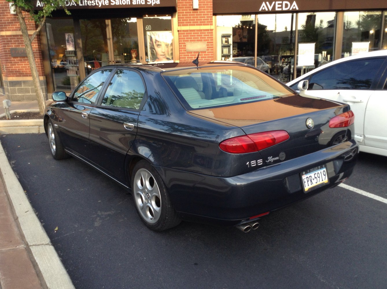 Rear view of sedan with dual exhaust and oval tail lights