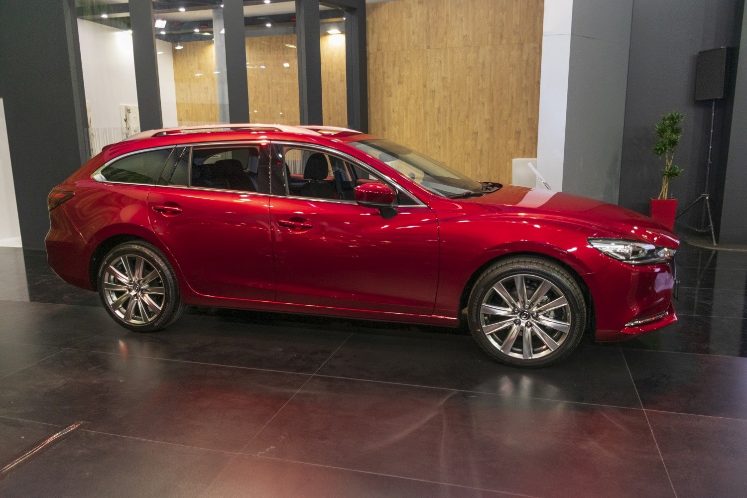 Red sporty station wagon with alloy wheels and sleek design