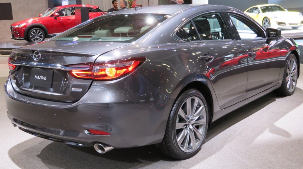 Rear view of sleek metallic gray sedan with modern taillights and single exhaust pipe