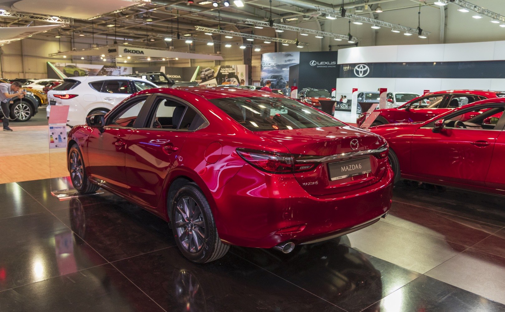 Rear exterior view of a red sedan with sleek taillights and sporty alloy wheels