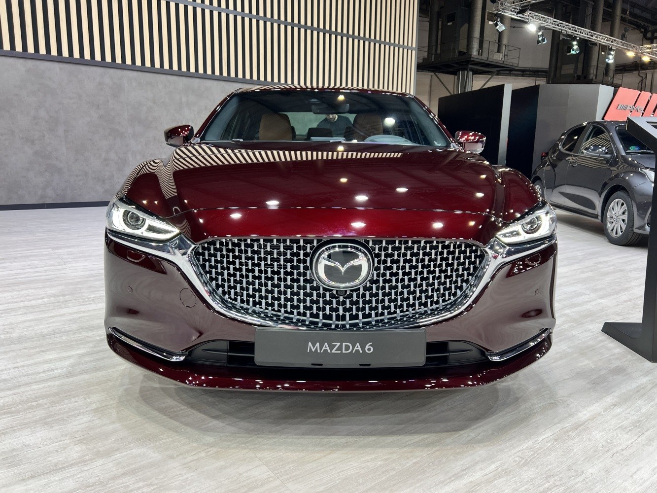 Front view with large patterned grille and sleek LED headlights