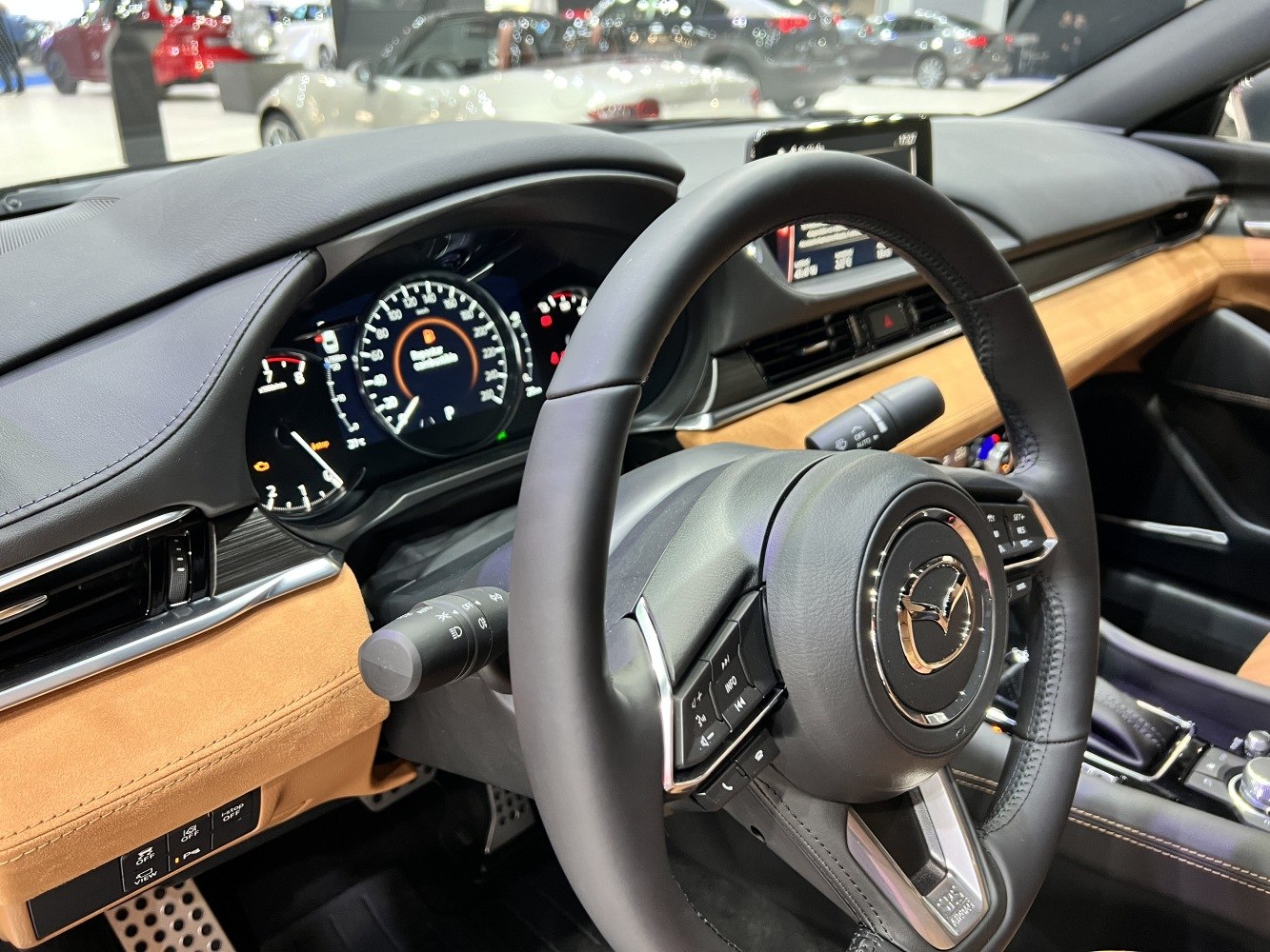 Interior view with steering wheel, dashboard, and digital instrument cluster