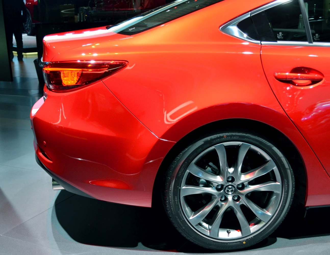 Rear side, taillight, and alloy wheel of a sedan