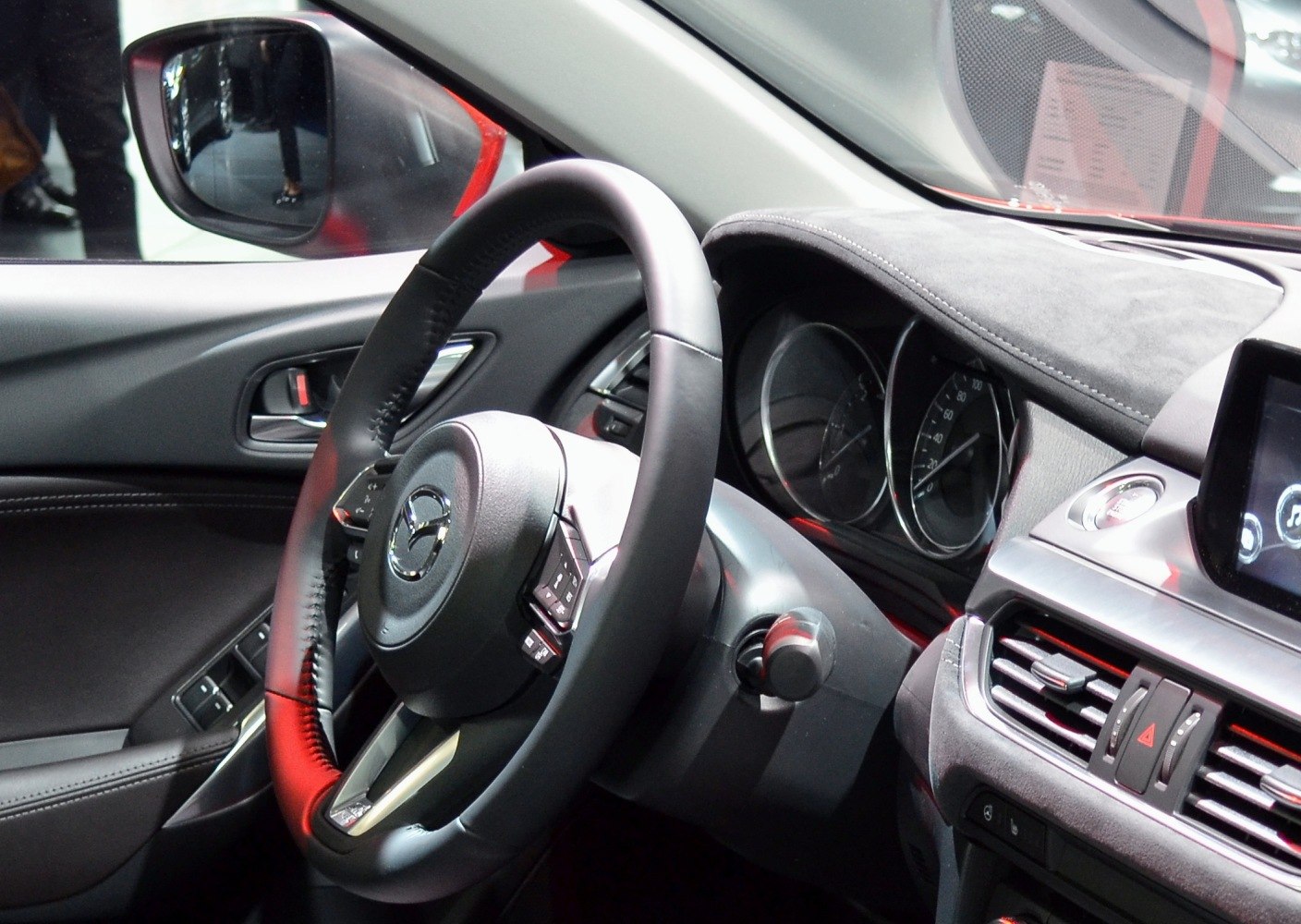 Close-up of steering wheel and dashboard with instrument cluster and infotainment screen