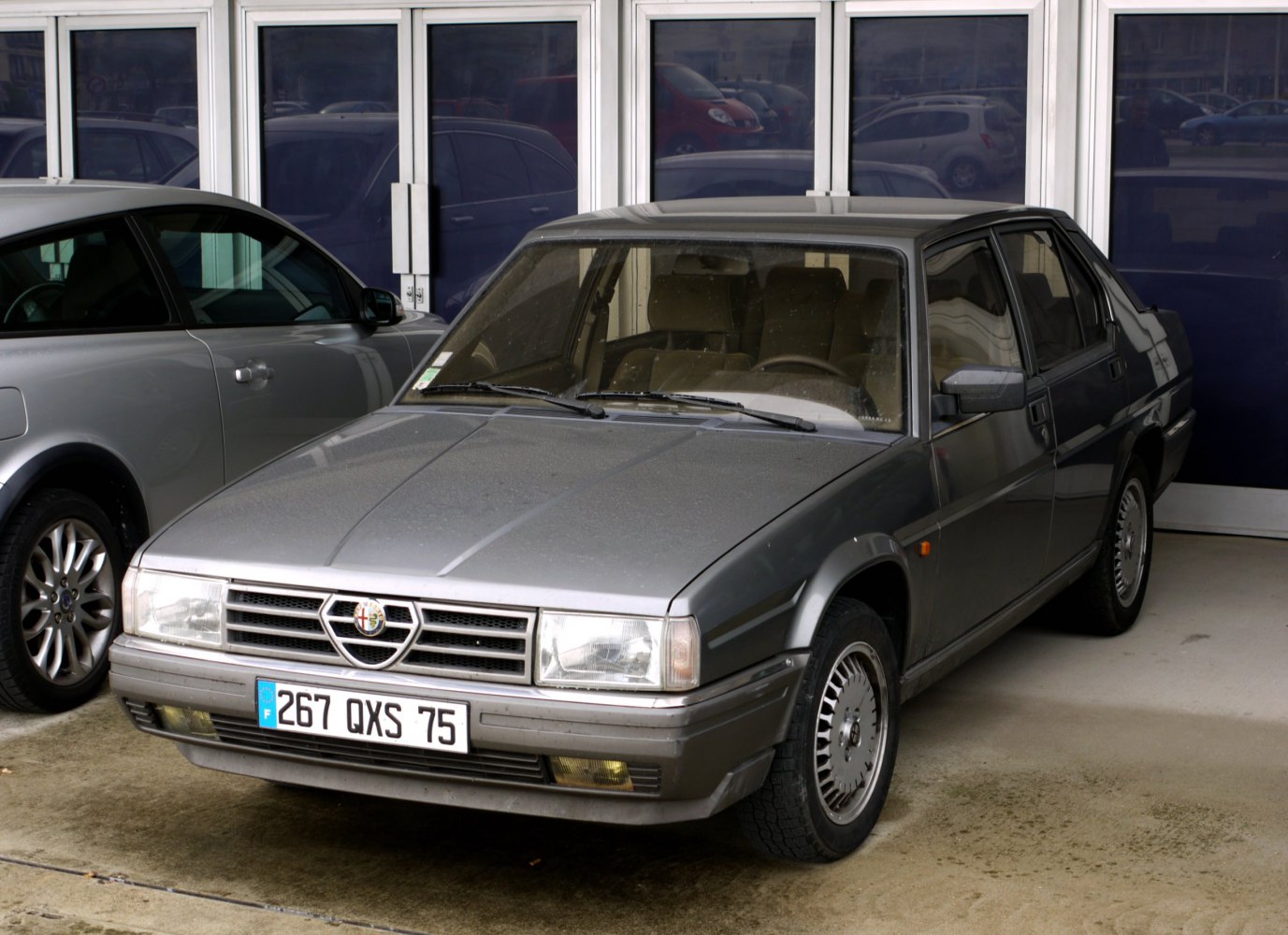 Boxy 1980s sedan front-side angle with distinctive grille and rectangular headlights
